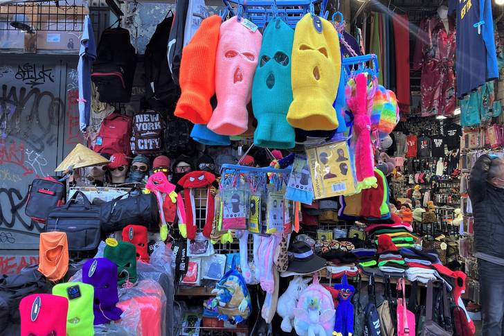 colorful ski masks hanging outside a tourist shop